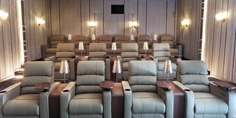 Premium recliner auditorium chairs by Flexi Seating System in a luxury home theater setup